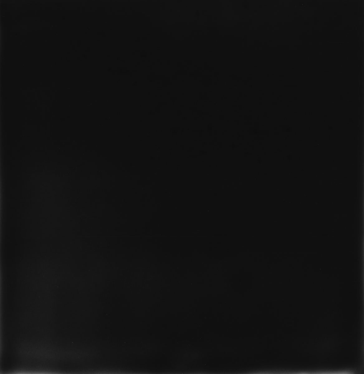 An almost entirely black photograph: the surface yields only a barely perceptible gradient, nothing stands out in it.