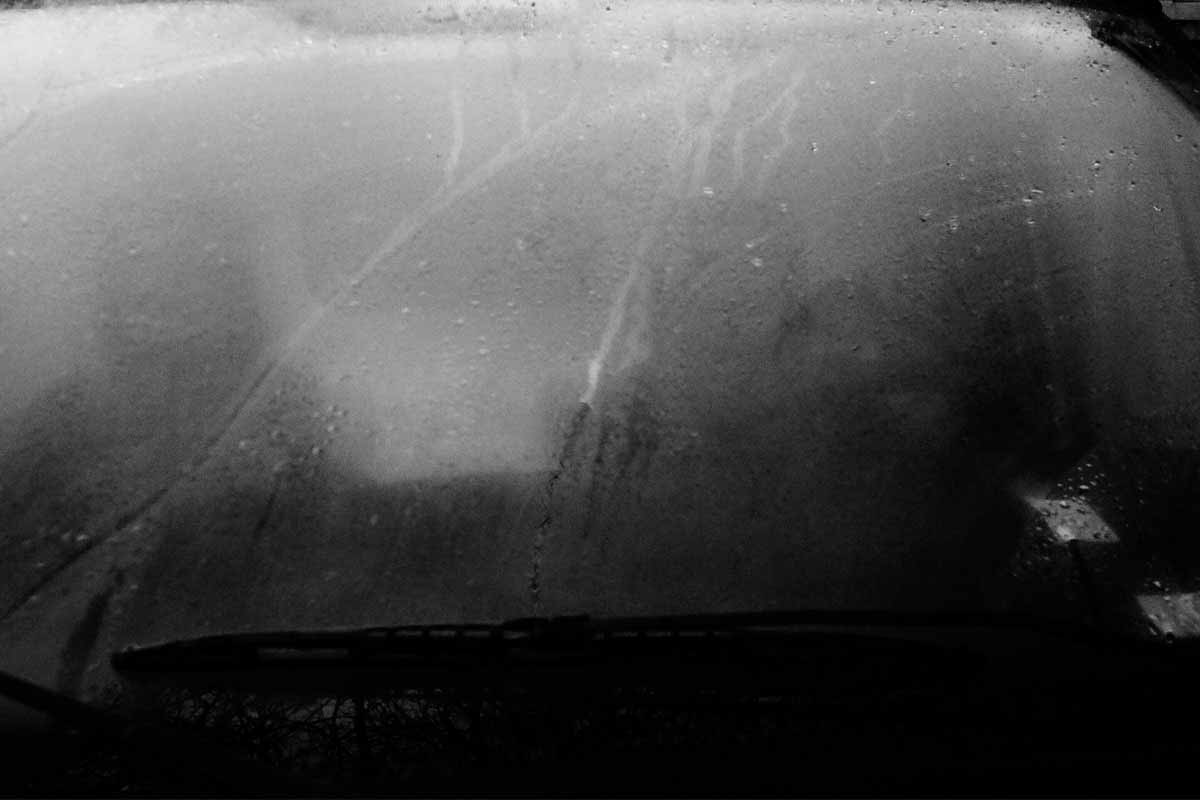 A misted windscreen, a wiper at the bottom of the frame.